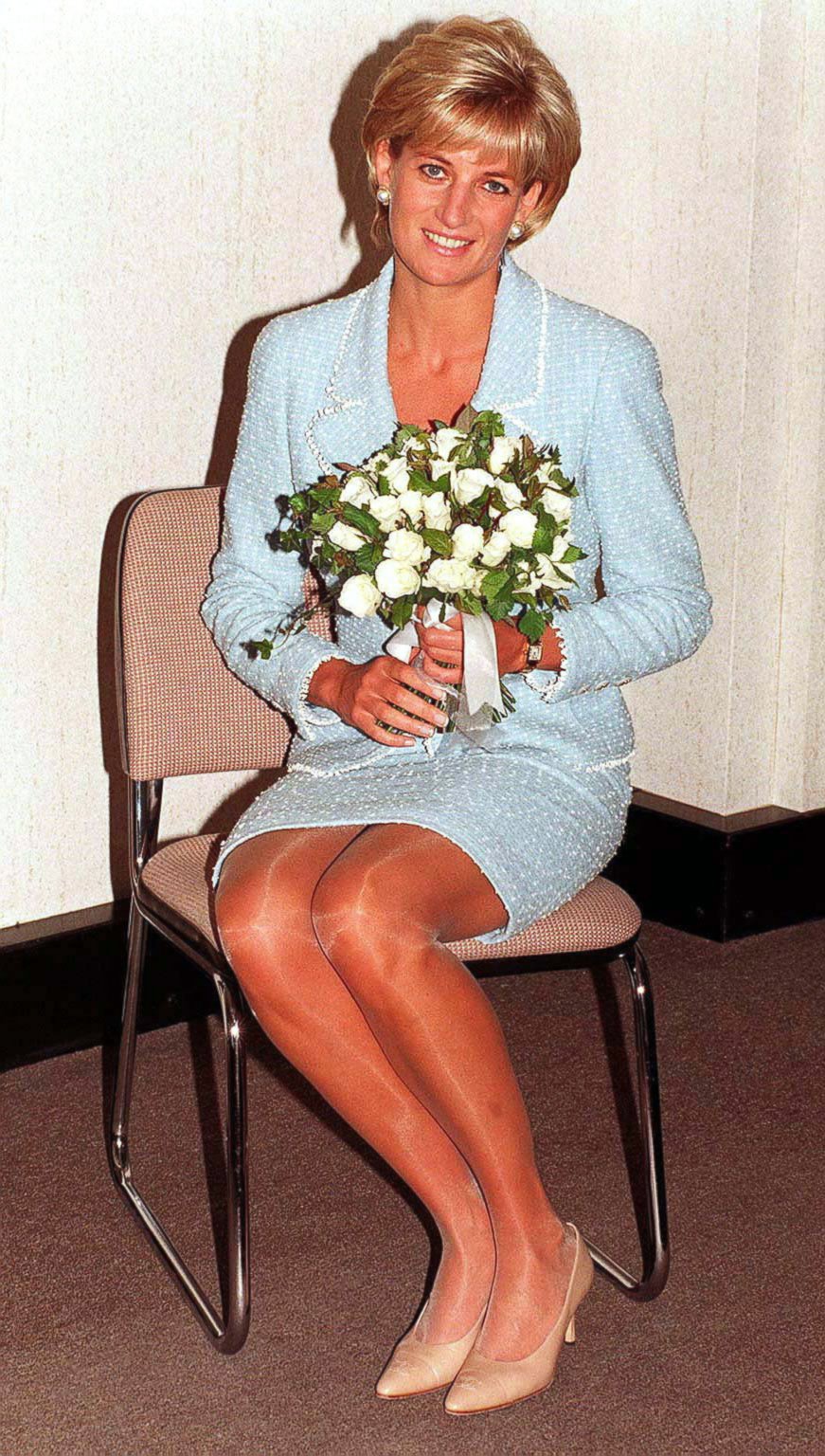 PHOTO: Diana, Princess of Wales is presented with the first rose to be named after her at the British Lung Foundation offices, April 21, 1997 in London, England. 