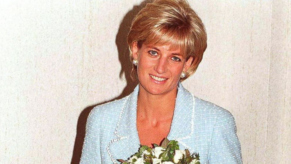 PHOTO: Diana, Princess of Wales is presented with the first rose to be named after her at the British Lung Foundation offices, April 21, 1997 in London, England.