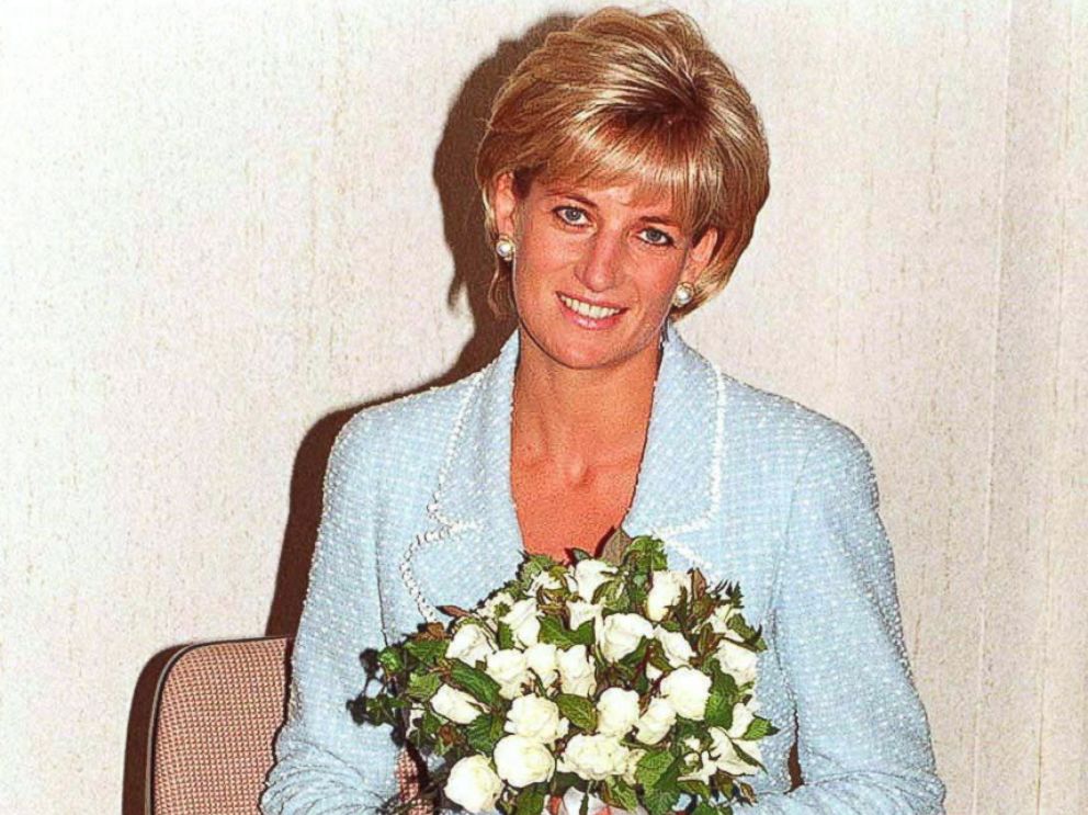 PHOTO: Diana, Princess of Wales is presented with the first rose to be named after her at the British Lung Foundation offices, April 21, 1997 in London, England.