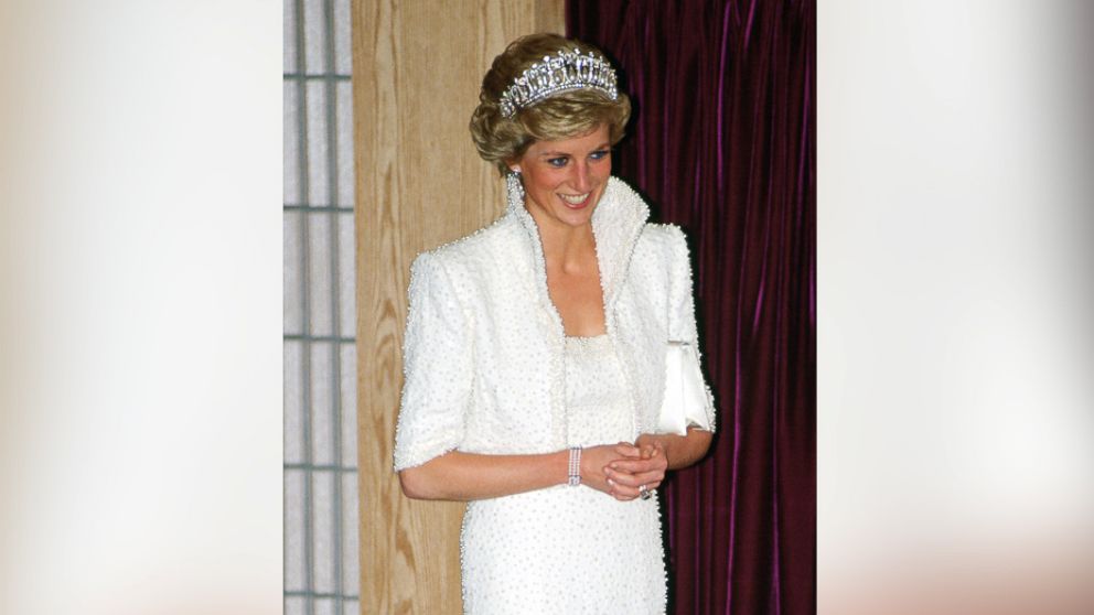 PHOTO: A 1990 Bruce Oldfield cream satin dress and a 1987 Catherine Walker pink satin evening gown (R) worn by princess Diana for an official portrait in 1987 at a press preview at Kensington Palace, on Feb. 22, 2017 in London.