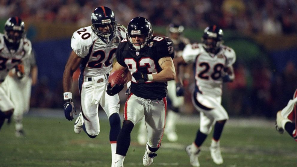 PHOTO: Tim Dwight of the Atlanta Falcons is pursued by corner back Tory James of the Denver Broncos as he returns a kick-off for a touchdown during Super Bowl XXXIII in Miami, Florida. 