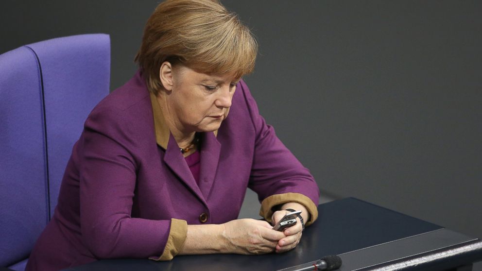 German Chancellor Angela Merkel checks her mobile phone during a session of the Bundestag on November 30, 2012 in Berlin, Germany. 