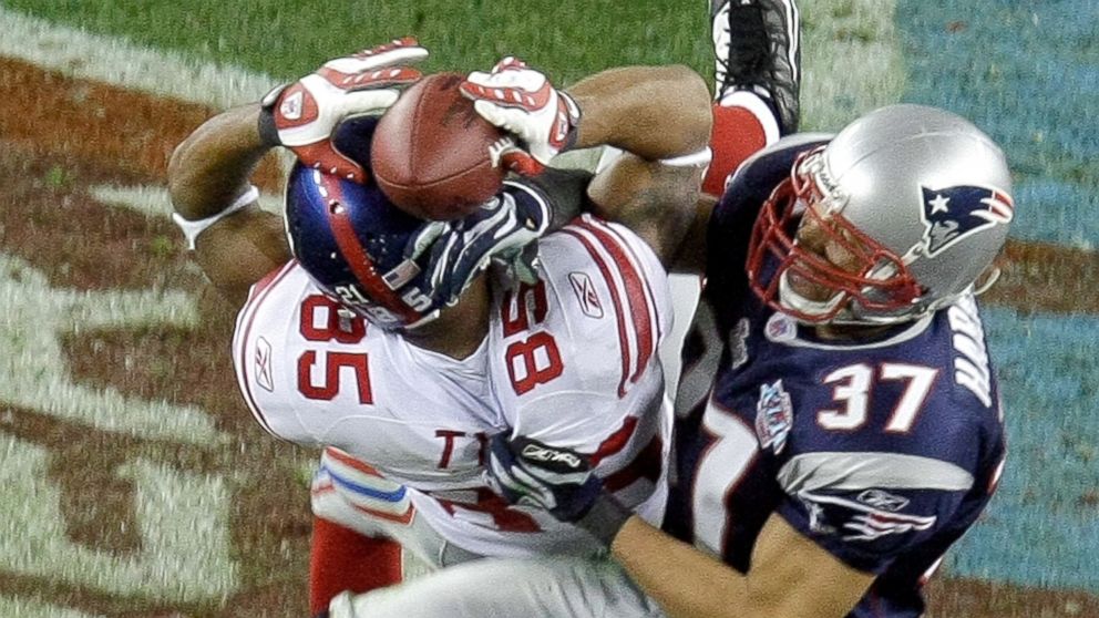 PHOTO: New York Giants receiver David Tyree (85) hauls in a long pass against the New England Patriots' Rodney Harrison (37) on the game-winning drive in a 17-14 victory over the New England Patriots at Super Bowl XLII in Glendale, Arizona, Feb. 3, 2008. 