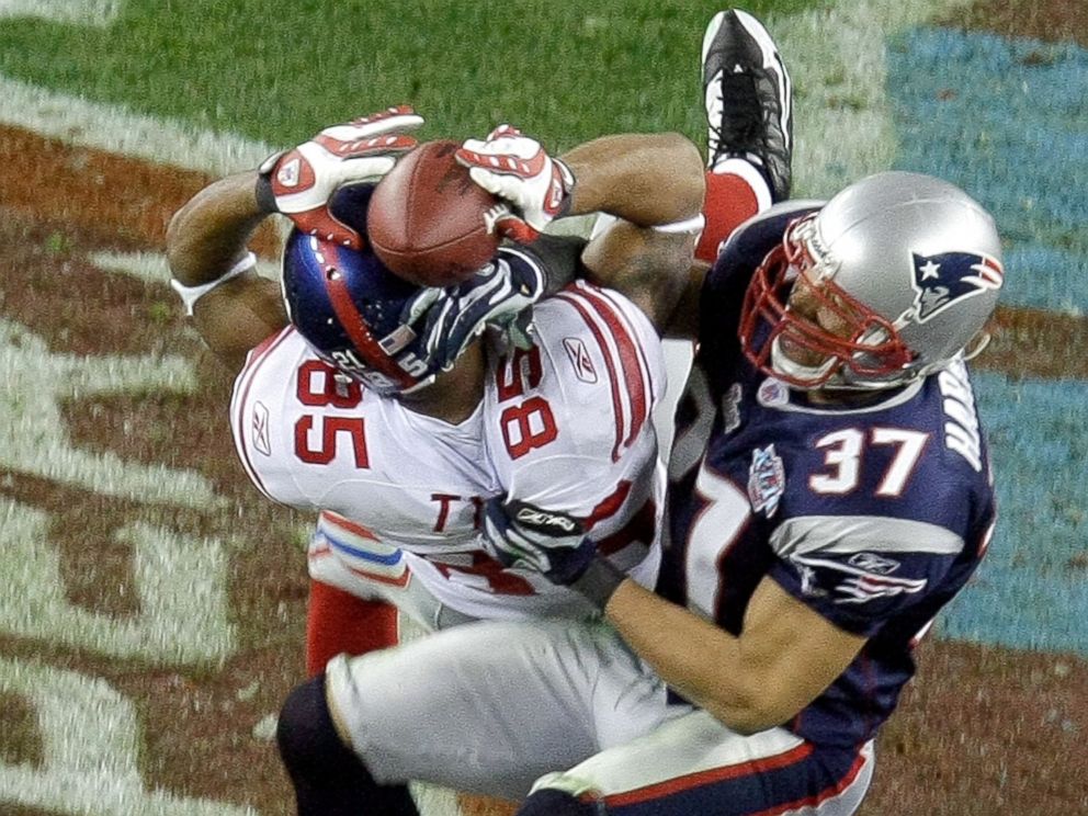 PHOTO: New York Giants receiver David Tyree (85) hauls in a long pass against the New England Patriots Rodney Harrison (37) on the game-winning drive in a 17-14 victory over the New England Patriots at Super Bowl XLII in Glendale, Arizona, Feb. 3, 2008.