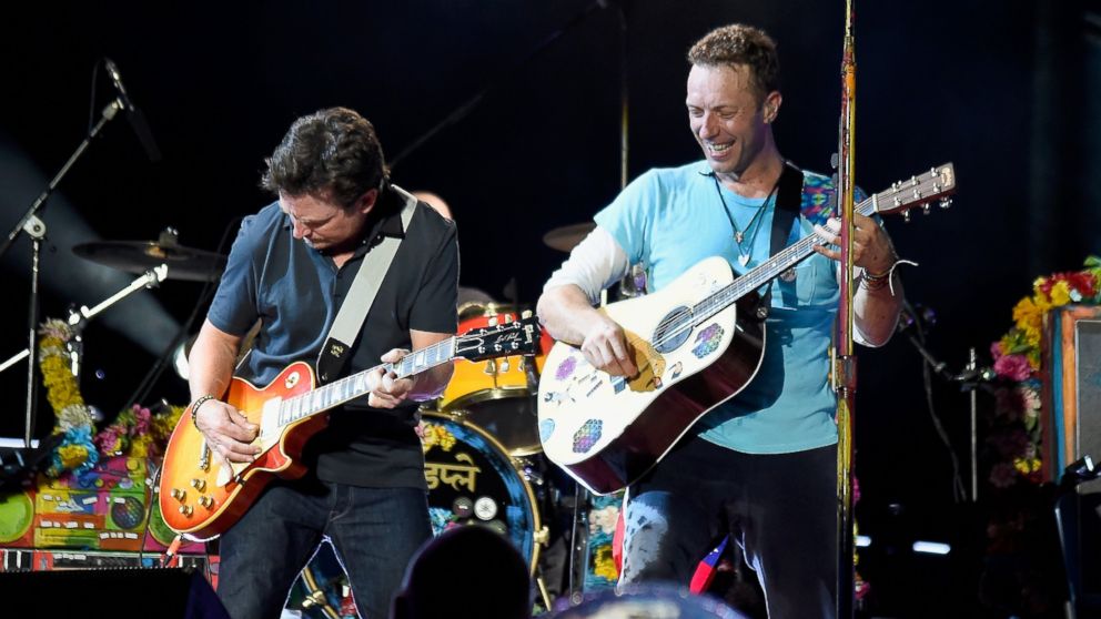 Actor Michael J. Fox, left,  performs onstage with recording artist Chris Martin of Coldplay during the Coldplay "A Head Full of Dreams" Tour at MetLife Stadium on July 17, 2016 in East Rutherford, New Jersey. 