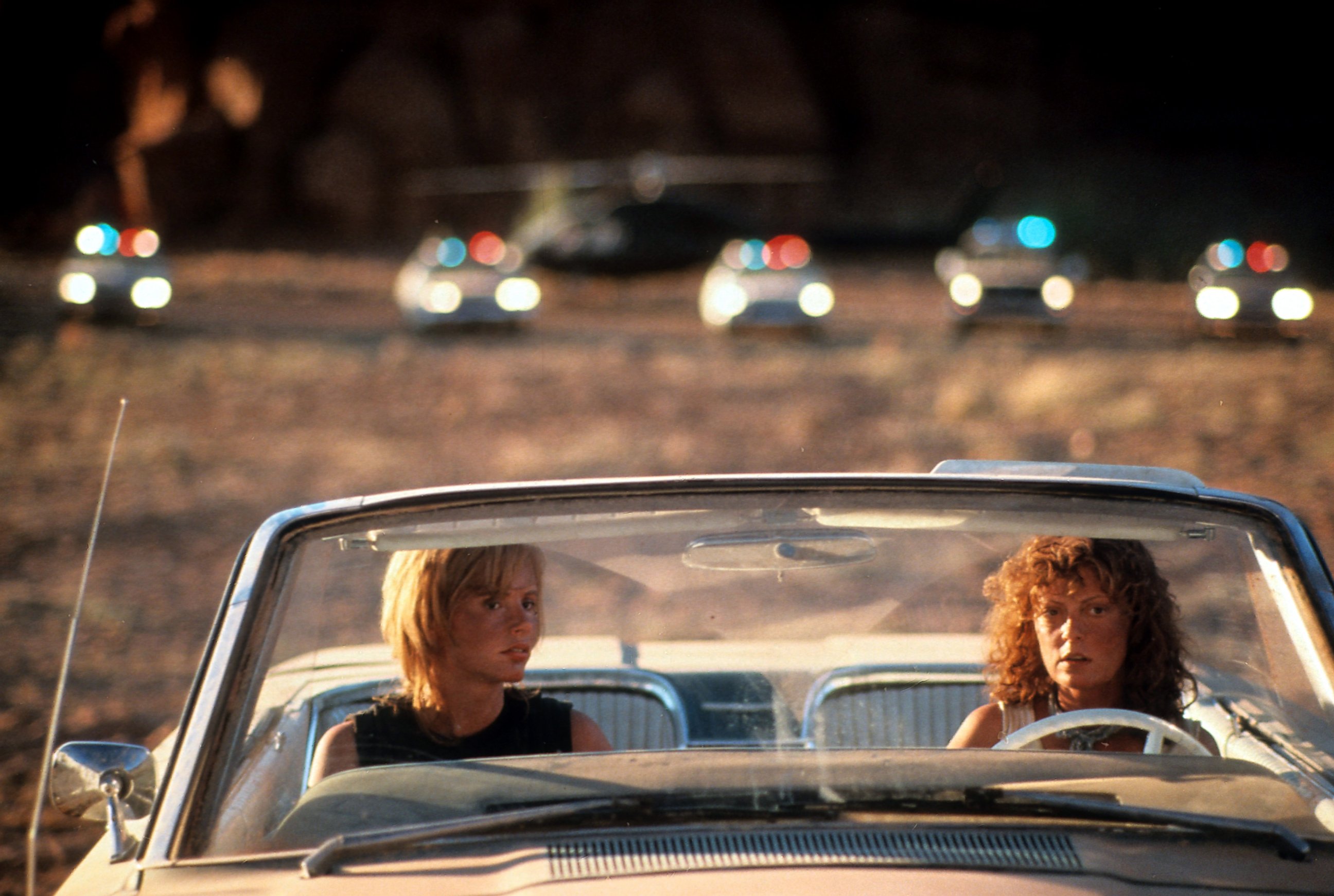 PHOTO: Geena Davis and Susan Sarandon sitting in their convertible with squad cars behind them in a scene from the film 'Thelma & Louise' in 1991.