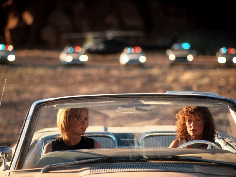PHOTO: Geena Davis and Susan Sarandon sitting in their convertible with squad cars behind them in a scene from the film Thelma & Louise in 1991.