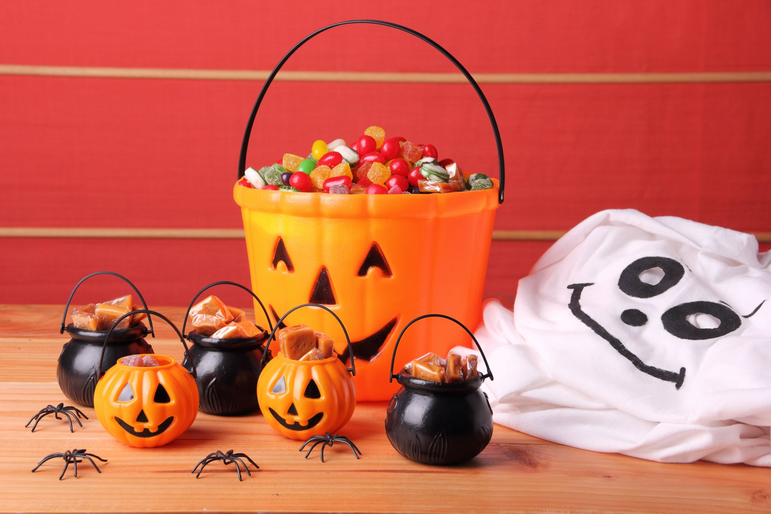 PHOTO: Ghost costume next to a bucket full of candy for Halloween.