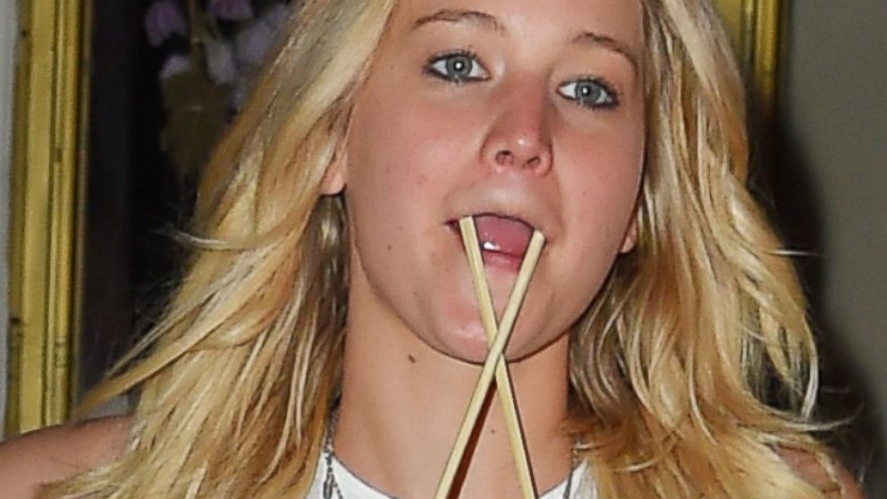Jennifer Lawrence puts chopsticks in her mouth then hair as she leaves Nobu after dinner in Tribeca, June 24, 2015, in New York.
