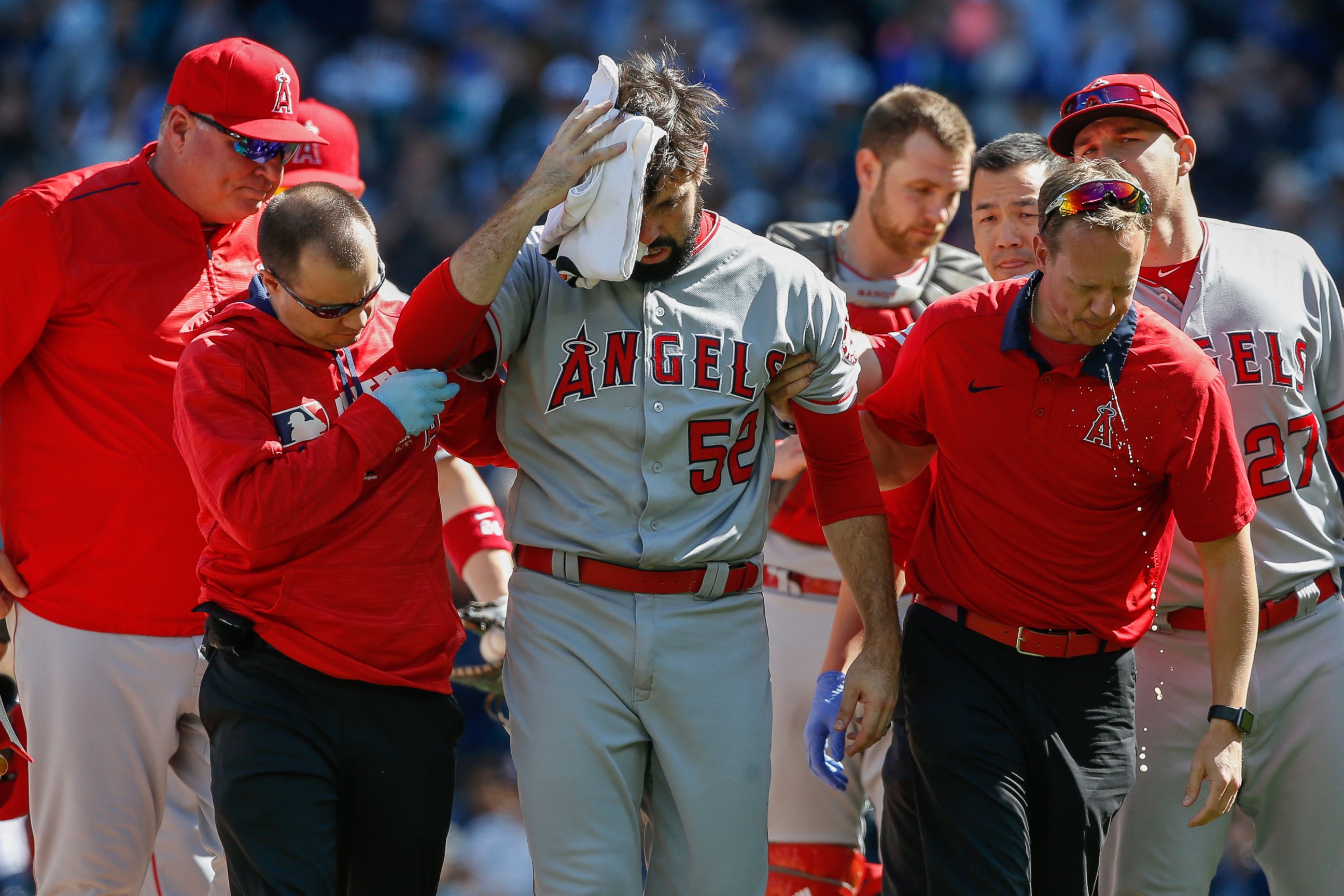 PHOTO: Starting pitcher Matt Shoemaker, #52 of the Los Angeles Angels of Anaheim, is helped off the field after being hit in the head with a batted ball off the bat of Kyle Seager of the Seattle Mariners, on Sept. 4, 2016, in Seattle.