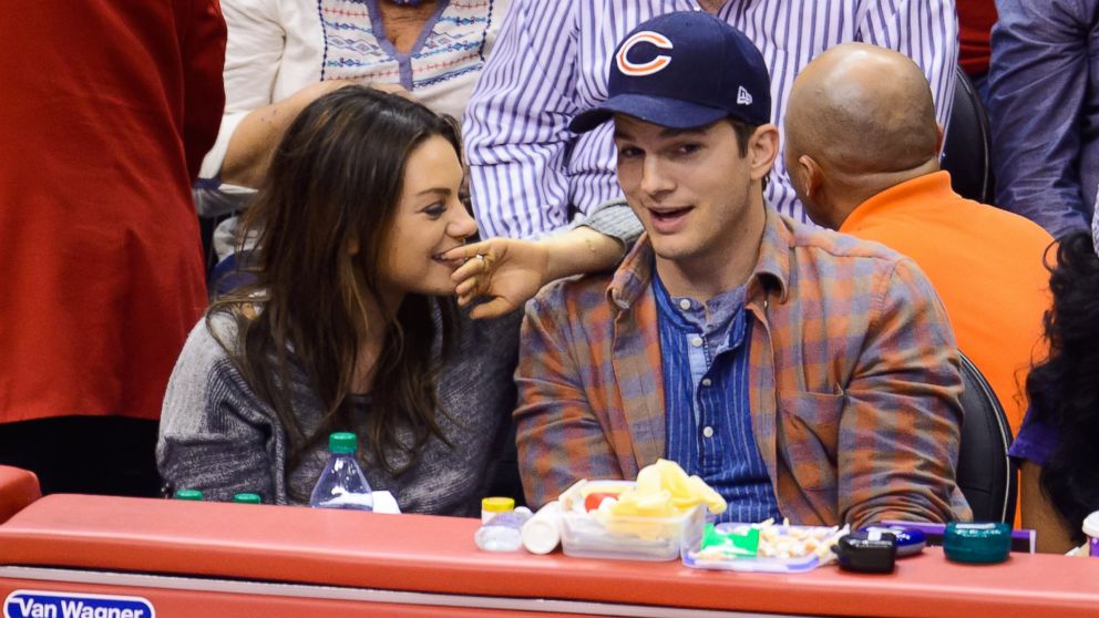 Mila Kunis, left and Ashton Kutcher attend a basketball between the Detroit Pistons and the Los Angeles Clippers at Staples Center, March 22, 2014 in Los Angeles.   