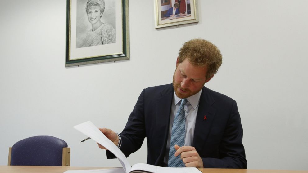 Prince Harry signs the visitors book during a visit to Mildmay hospital, a dedicated HIV hospital, to mark the opening of the new purpose built facility at Mildmay Hospital, Dec. 14, 2015 in London. 