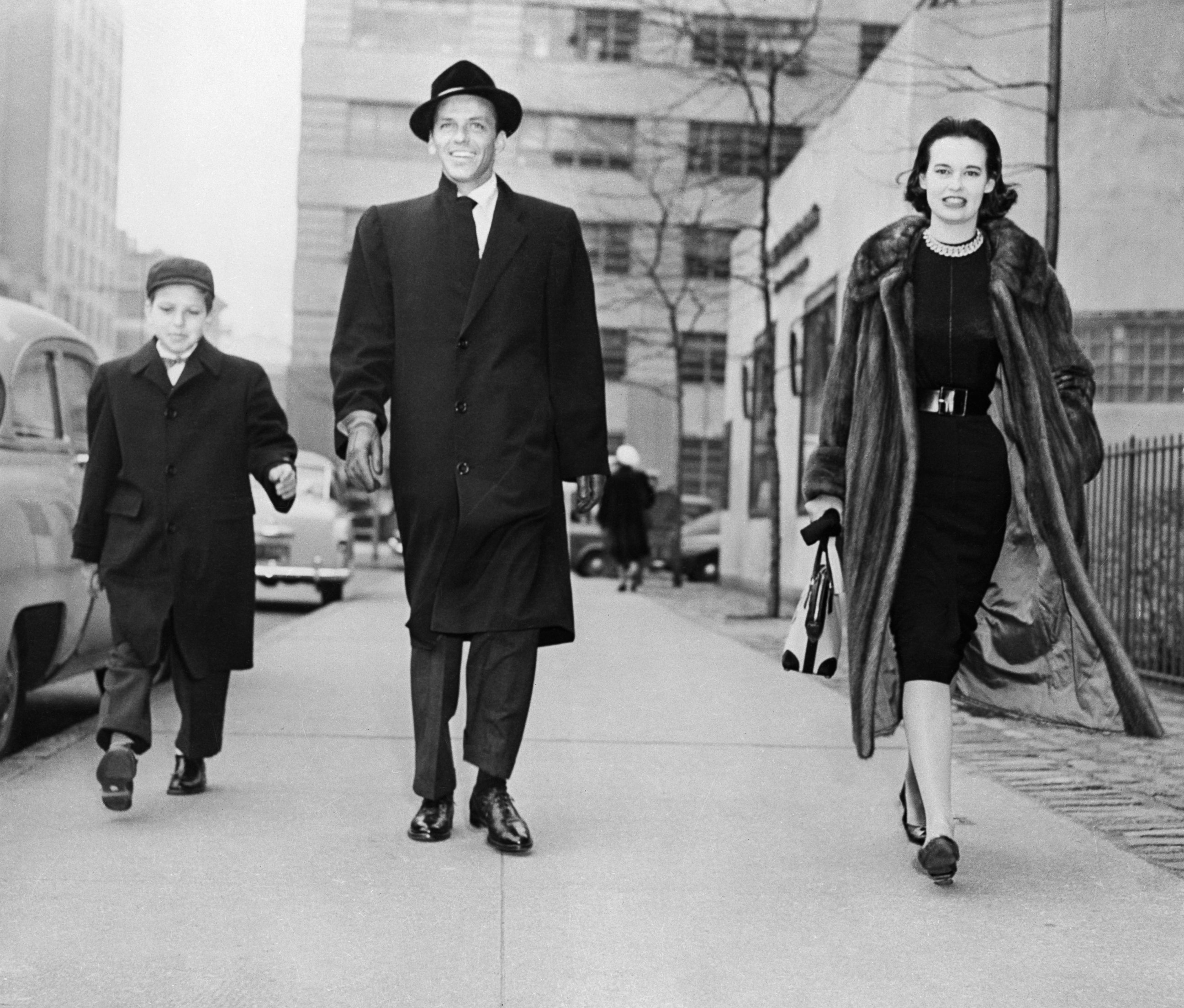 PHOTO: Gloria Vanderbilt Stokowska strolling with actor-singer Frank Sinatra and the latter's son, Frank, Jr., on New York's First Avenue, Dec. 31, 1954.
