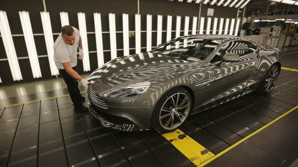 In this file photo, an Aston Martin Vanquish is inspected by hand inside a light booth at the company headquarters and production plant on Jan. 10, 2013 in Gaydon, England. 