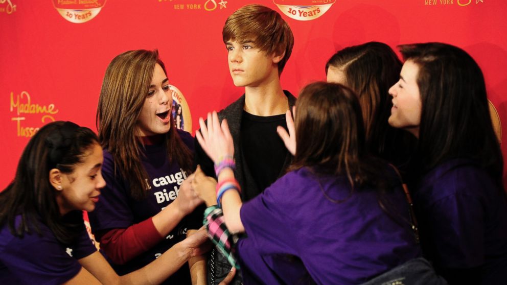 In this file photo, fans of Justin Bieber crowd his wax figure during its unveiling ceremony at Madame Tussauds on Mar. 15, 2011 in New York City. 