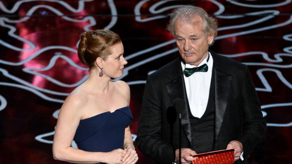 Amy Adams, left, and Bill Murray, right, speak onstage during the Oscars on Mar. 2, 2014 in Hollywood, Calif. 
