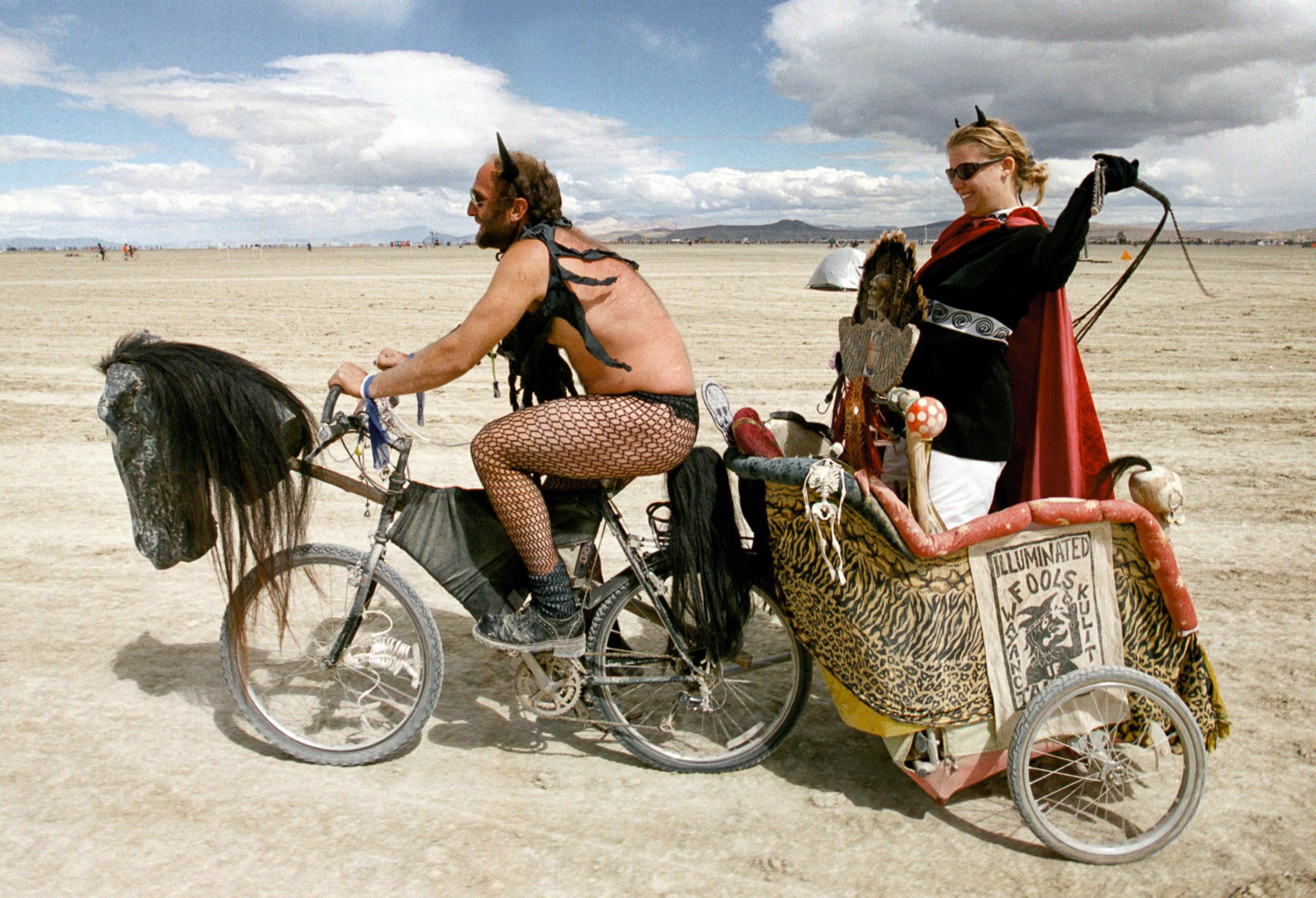 PHOTO: A dominating woman gets a chariot ride across the playa during the15th annual Burning Man festival September 2, 2000 in the Black Rock Desert near Gerlach, Nevada.
