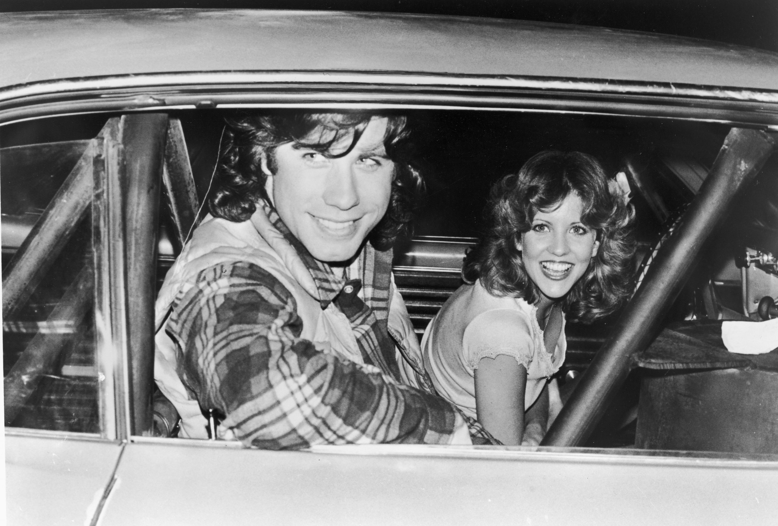 PHOTO: John Travolta and Nancy Allen pose in a car on the set of the film "Carrie," directed by Brian De Palma, 1976.