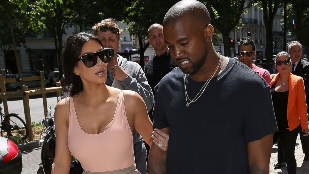 Kim Kardashian, left, and Kanye West, right, are seen strolling in Paris, France on May 19, 2014.  