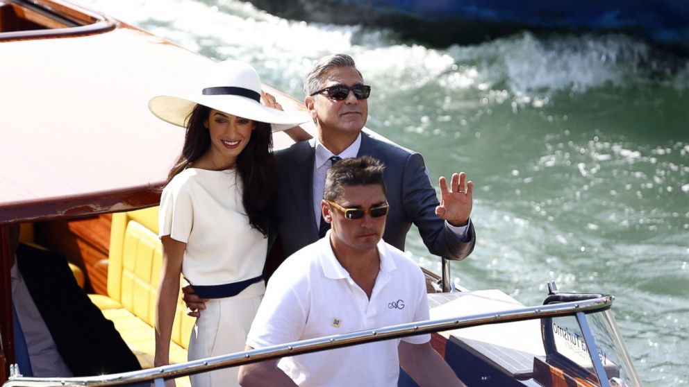 George Clooney and Amal Alamuddin leave the palazzo Ca Farsetti on a taxi boat, Sept. 29, 2014, in Venice, after a civil ceremony to officialise their wedding.