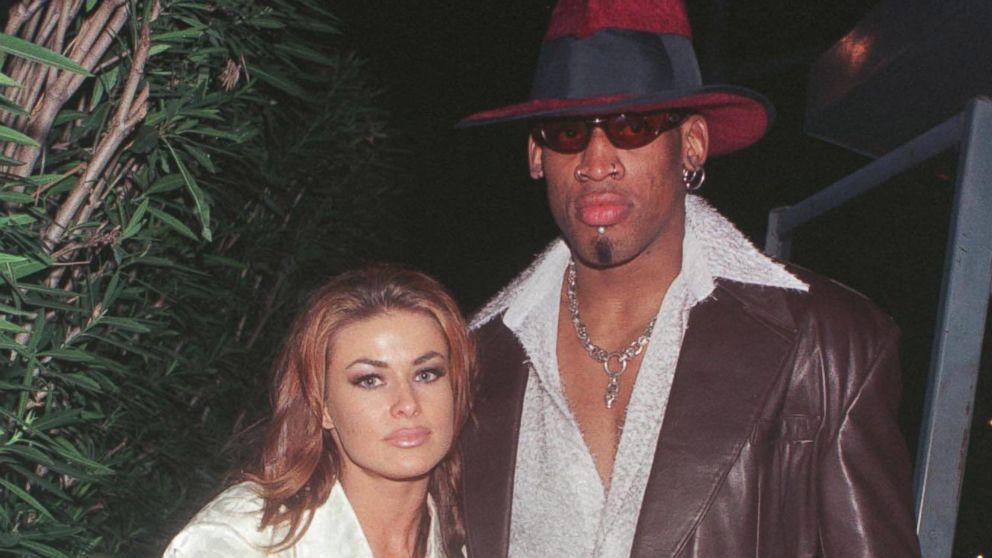 New Laker Dennis Rodman celebrates his first winning game out on the town at GOODBAR with wife Carmen Electra in Beverly Hills, CA, in this Feb. 26, 1999, file photo.