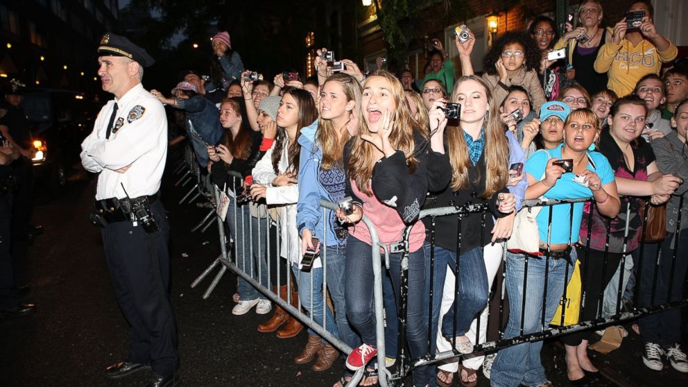 Fans react as musicians Nick Jonas, Joe Jonas, and Kevin Jonas of Jonas Brothers arrive at a free concert at Irving Plaza, June 11, 2009 in New York.