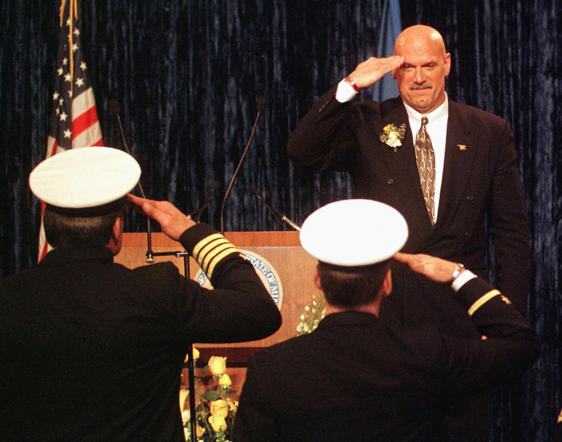 PHOTO: Minn. Governor Jesse Ventura salutes Naval Officers he invited to his inaugural after taking the oath of office to become Minnesota's 38th governor at the State Capitol in St. Paul, Minn., Jan. 4, 1999.
