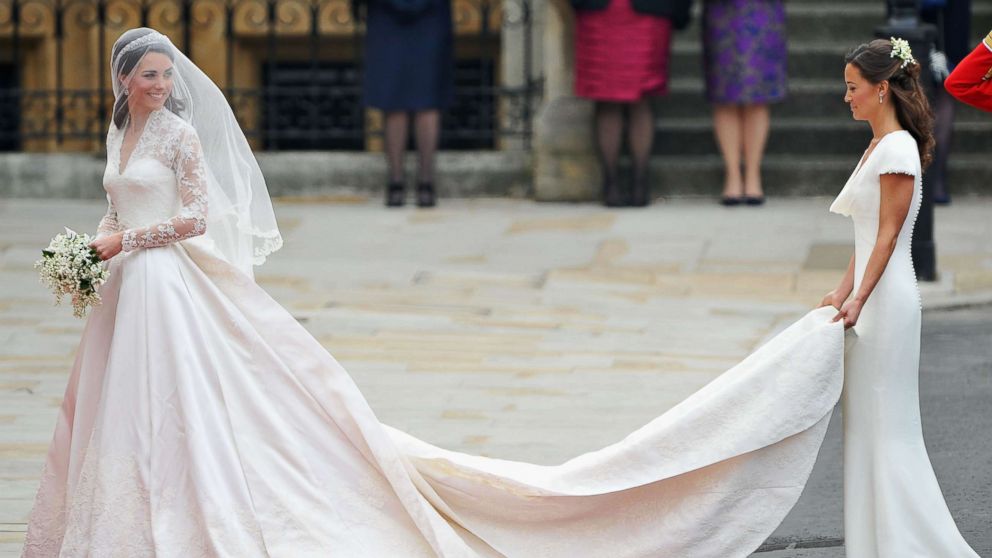 PHOTO: Catherine Middleton waves to the crowds as her sister and Maid of Honor Pippa Middleton holds her dress before walking in to the Abbey to attend the Royal Wedding of Prince William to Catherine Middleton at Westminster Abbey on April 29, 2011.