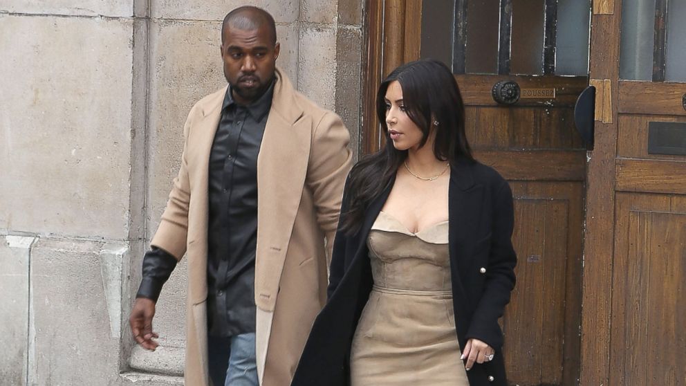 Kim Kardashian and Kanye West leave the 'Maison Martin Margiela' showroom on May 21, 2014 in Paris, France.