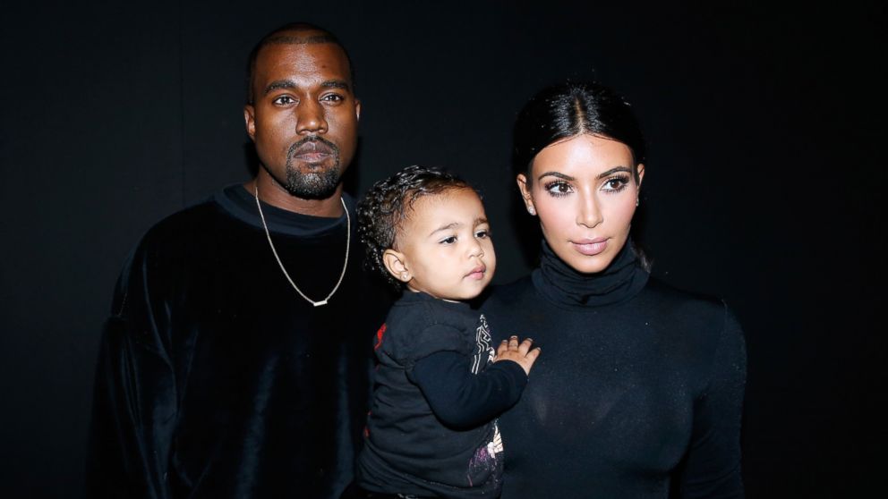 Kanye West, Kim Kardashian and their daughter North West attend the Balenciaga show as part of the Paris Fashion Week Womenswear Spring/Summer 2015, Sept. 24, 2014 in Paris.  