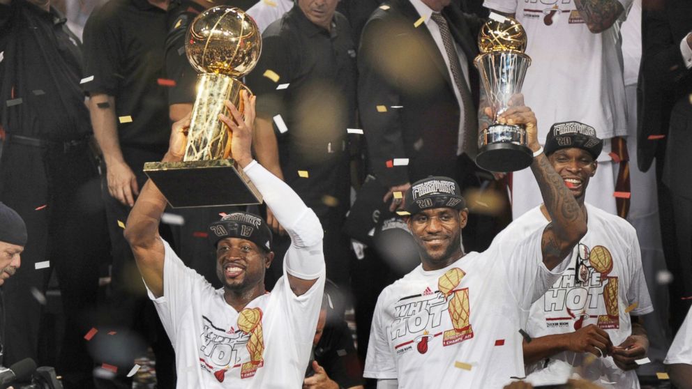 PHOTO: With trophies in hand, the Miami Heat's LeBron James and Dwyane Wade celebrate after a 95-88 win against the San Antonio Spurs in Game 7 of the NBA Finals in Miami, June 20, 2013.