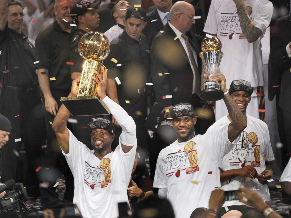 PHOTO: With trophies in hand, the Miami Heat's LeBron James and Dwyane Wade celebrate after a 95-88 win against the San Antonio Spurs in Game 7 of the NBA Finals in Miami, June 20, 2013.