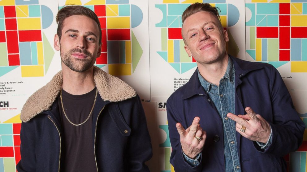Ryan Lewis, left, and Macklemore pose backstage during the Seattle Musicians for Childrenâ??s Hospital benefit at The Showbox Market, Dec. 14, 2013, in Seattle.