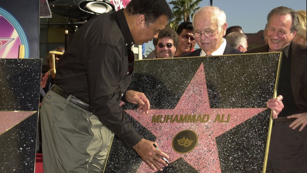 PHOTO:Muhammad Ali signing a replica of his Star on the Hollywood Walk of Fame after a star ceremony for him, Jan. 11, 2002, in Los Angeles.   