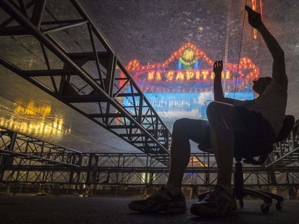 PHOTO: Rick Gamboa and his coworker patch small holes in a plastic roof that will protect OSCARs red carpet from the rain during the preparations for the upcoming 86th Academy Awards on Feb. 24, 2014.