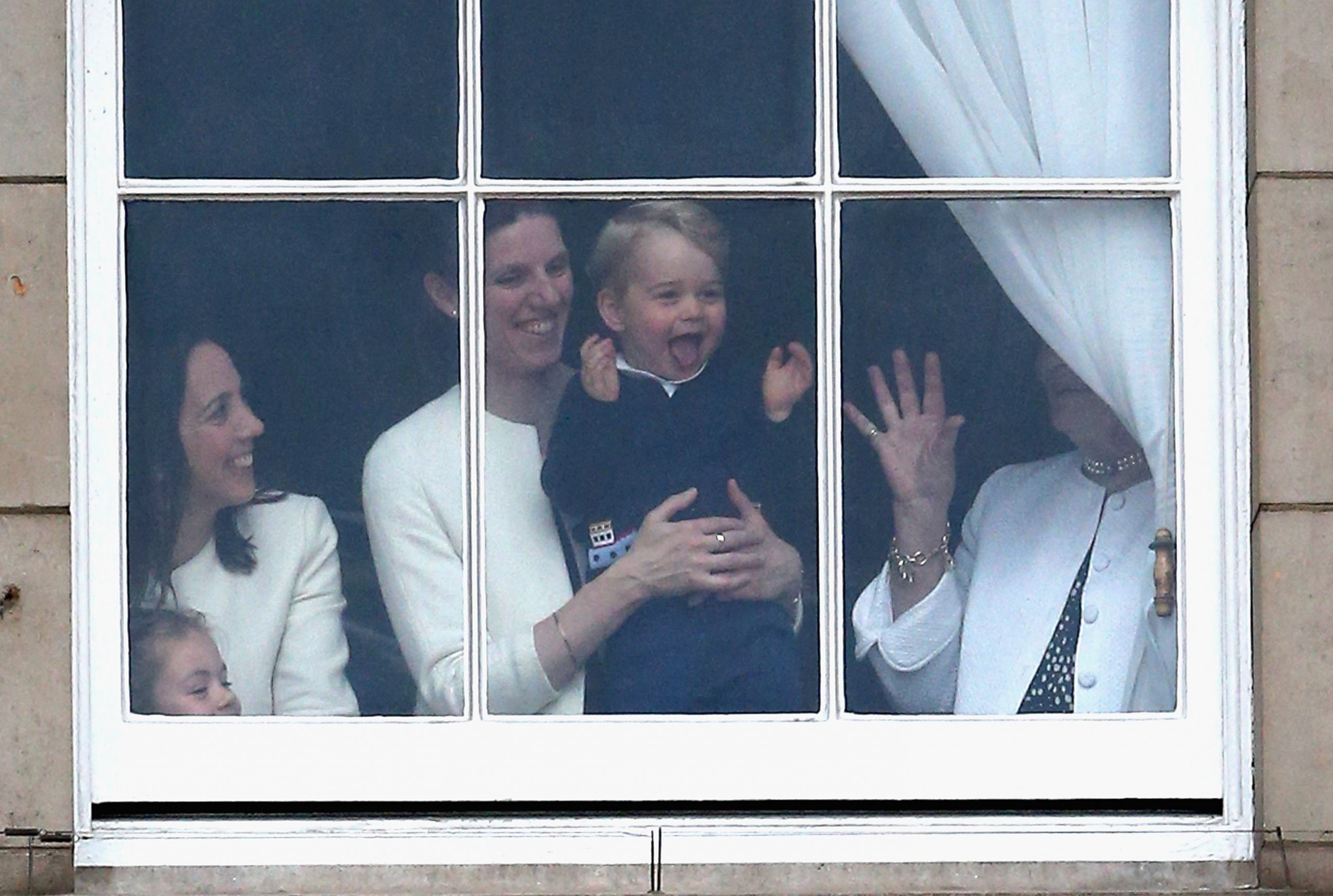 PHOTO: Prince George of Cambridge is held by his nanny Maria Teresa Turrion Borrallo  at the window of Buckingham Palace as he watches the Trooping The Color ceremony in London, June 13, 2015. 