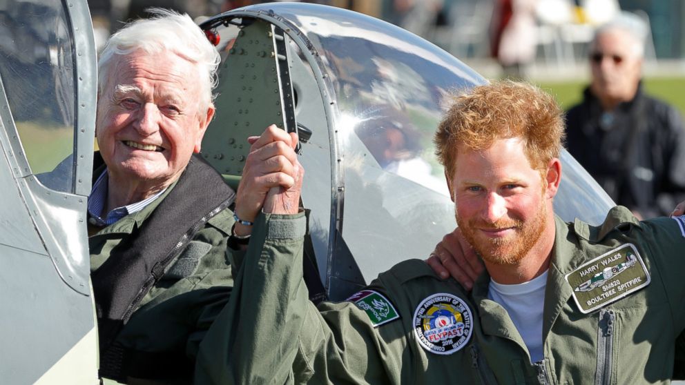 Prince Harry holds hands with 95 year old Battle of Britain Veteran Tom Neil after he landed back at Goodwood Aerodrome in his Spitfire aircraft following a Battle of Britain Flypast on Sept. 15, 2015 in Chichester, England. 