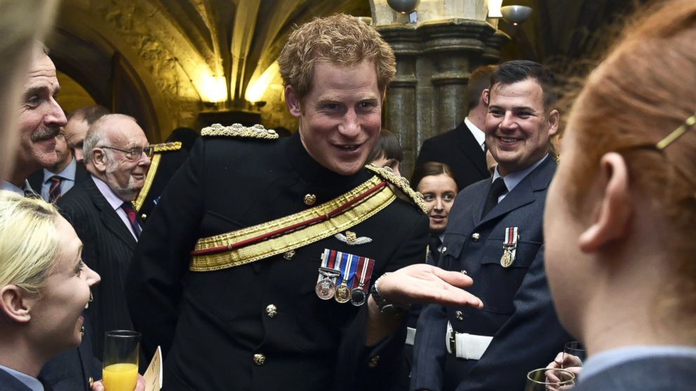 Britain's Prince Harry speaks with armed forces personnel during a reception at Guildhall following a memorial service to mark the end of Britain's combat operations in Afghanistan in central London, March 13, 2015.