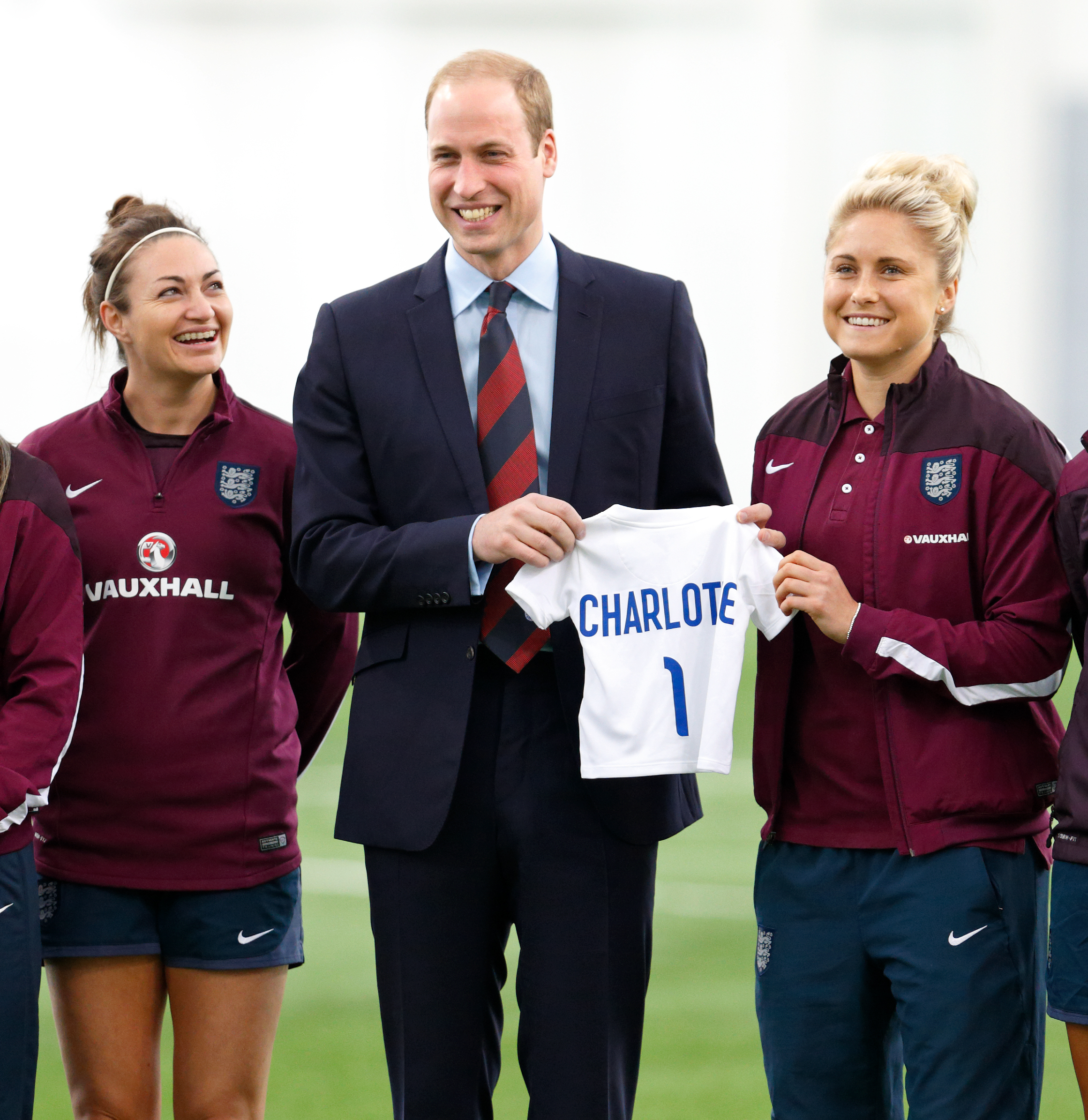 PHOTO: Prince William, Duke of Cambridge receives an England football shirt for daughter Princess Charlotte of Cambridge from Captain Steph Houghton, right, at St George's Par, May 20, 2015 in Burton-upon-Trent, England.