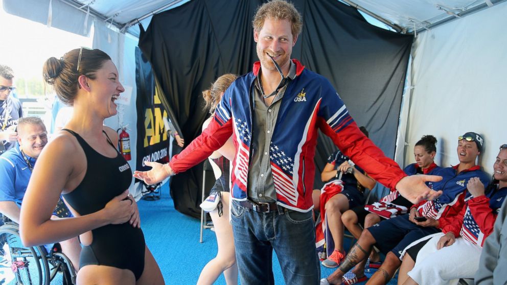 PHOTO:Prince Harry tries on USA Invictus Team Member Elizabeth Marks's Team USA jersey in the competitor's tent at the swimming pool during the Invictus Games Orlando 2016 at ESPN Wide World of Sports, May 11, 2016, in Orlando, Fla. 