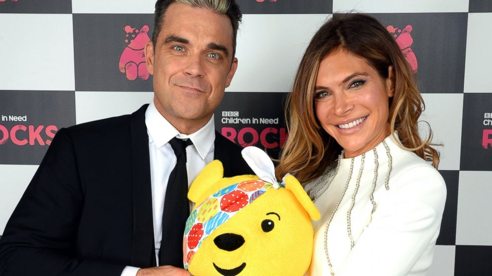 Robbie Williams and wfie Ayda Field pose backstage during the 'BBC Children In Need Rocks' at Eventim, Nov. 12, 2013, in London. 