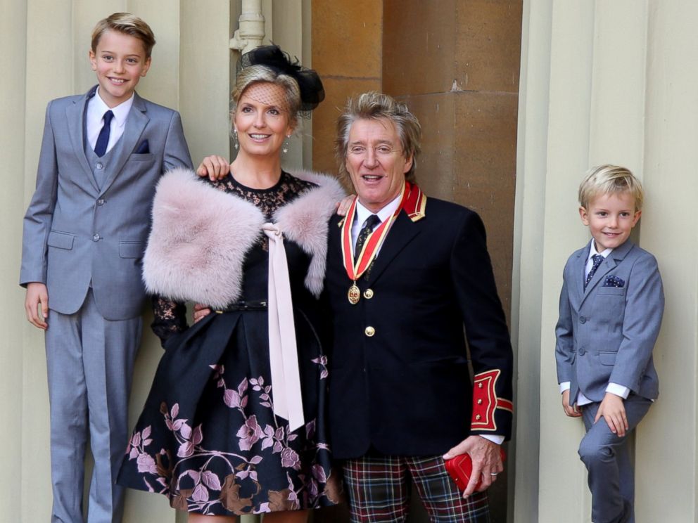 PHOTO: Sir Rod Stewart with his wife, Penny Lancaster and children Alastair and Aiden after he received his knighthood in recognition of his services to music and charity at Buckingham Palace, Oct. 11, 2016, in London.