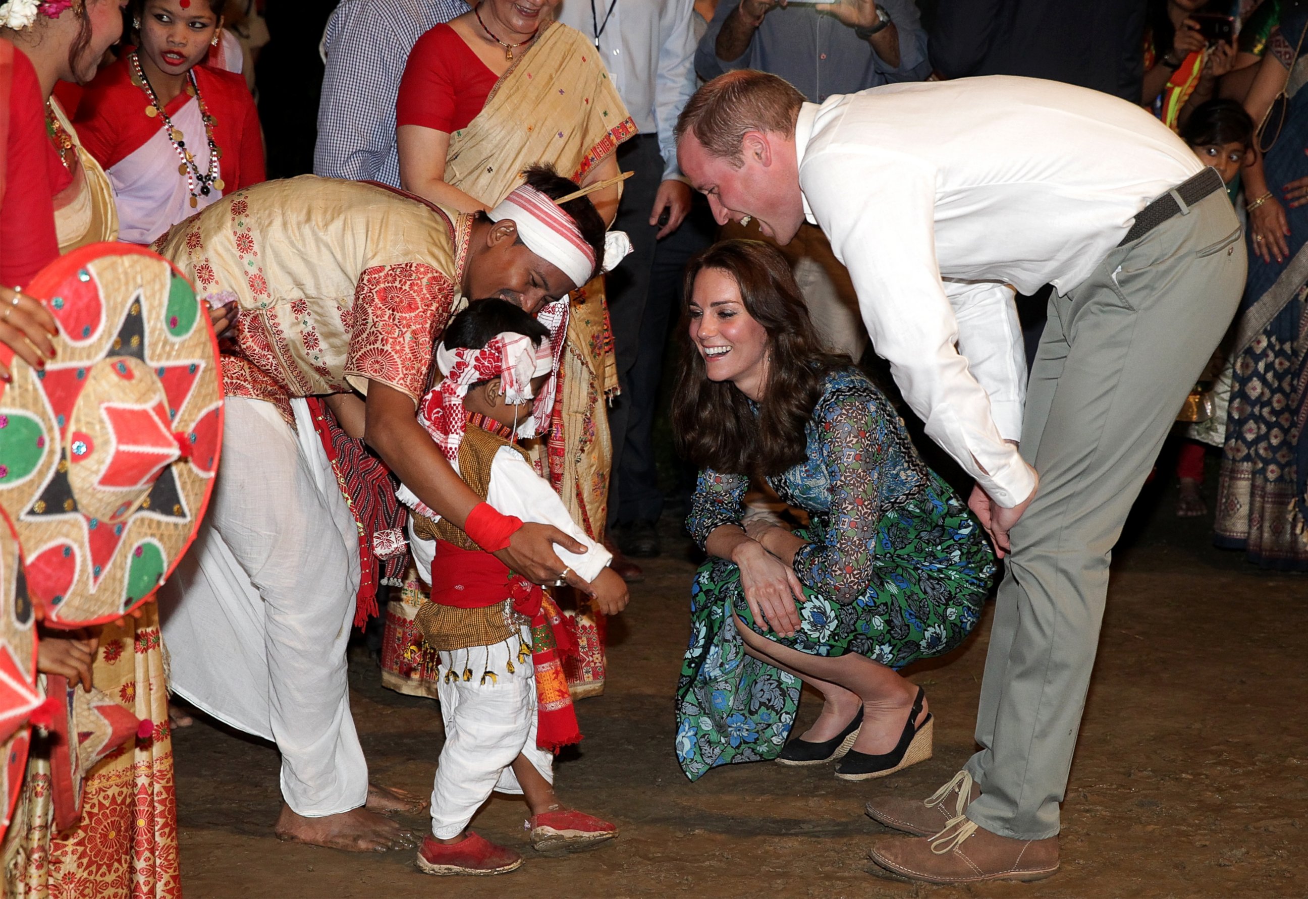 PHOTO:Catherine, Duchess of Cambridge and Prince William, Duke of Cambridge meet a young dancer as they watch dancing by the fireside during a Bihu Festival Celebration at Diphlu River Lodge, April 12, 2016, in Kaziranga, India.  