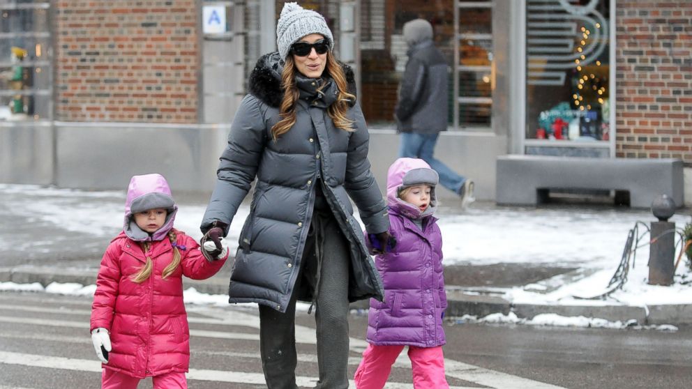Sarah Jessica Parker walks with her twin daughters, Tabitha Broderick and Loretta Broderick, Dec. 17, 2013 in New York.