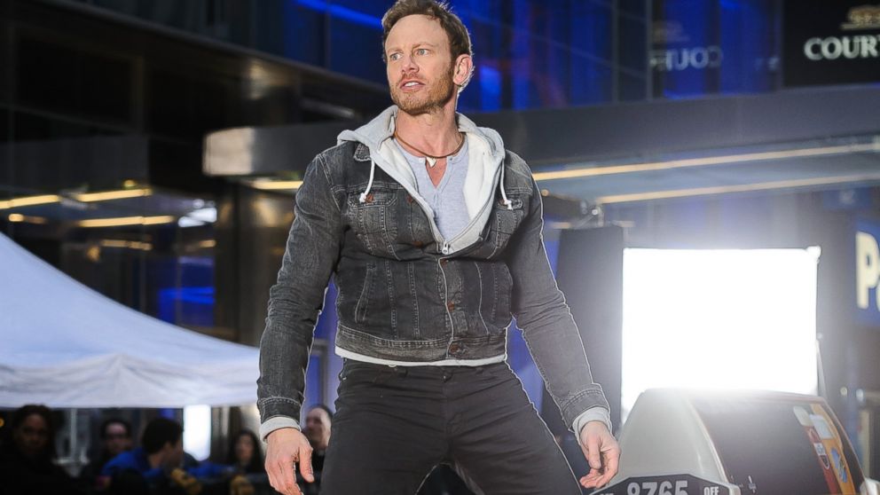 PHOTO: Ian Ziering stands on a taxi on the set of "Sharknado 2" in New York, Feb. 19, 2014.