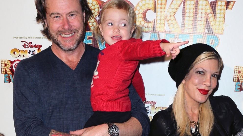 Dean McDermott and Tori Spelling pose with daughter Hattie Margaret McDermott at "Rockin' Ever After" presented at the Staples Center in Los Angeles, Dec. 12, 2013.