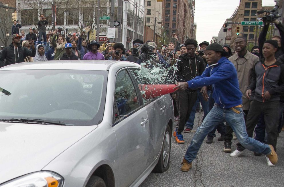 PHOTO: Allen Bullock uses a traffic cone to beak the window of a Baltimore Police car as he protests the death Freddie Gray, in Baltimore, Maryland, April 25, 2015. 