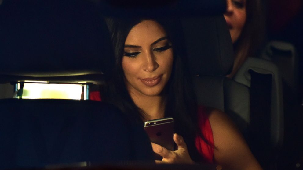 Kim Kardashian looks at her iPhone as she sits in a car after visiting the genocide memorial, which commemorates the 1915 mass killing of Armenians in the Ottoman Empire, in Yerevan, Armenia, April 10, 2015.