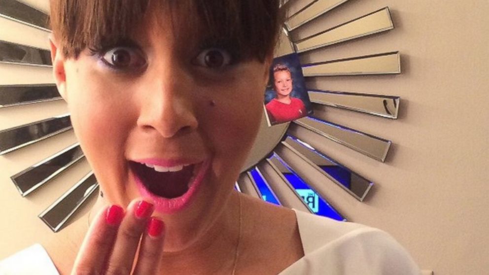 Tamera Mowry-Housley poses with a pregnancy test in a photo posted to Instagram, Jan. 4, 2015.