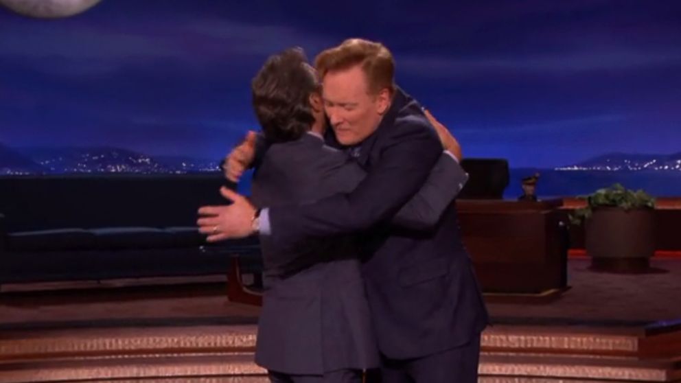Conan O'Brien hugs his former bandleader Max Weinberg, Oct. 28, 2014 on "Conan."